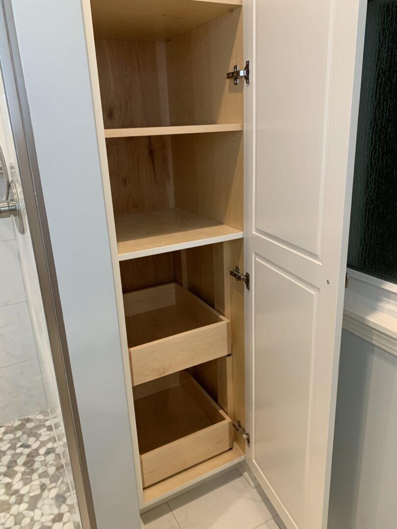 A bathroom cabinet with drawers in it.