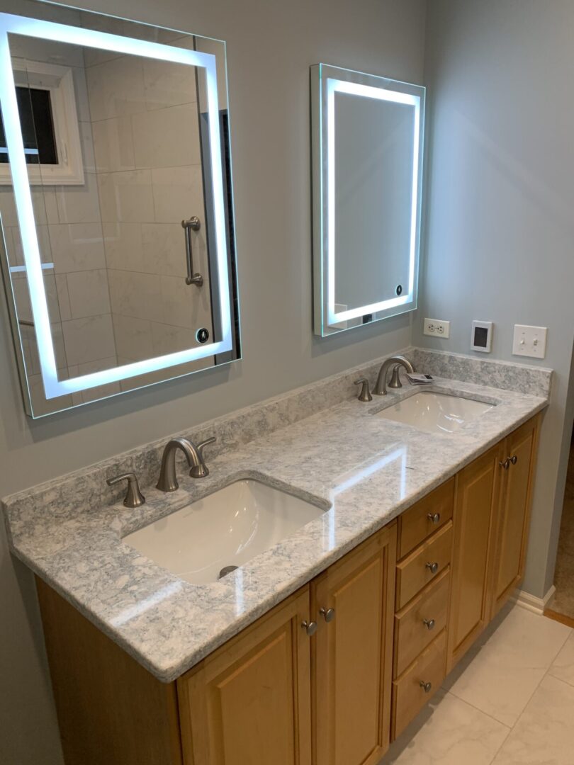 A bathroom with two sinks and mirrors.