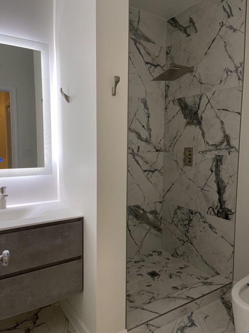 A marble bathroom with a toilet and sink.