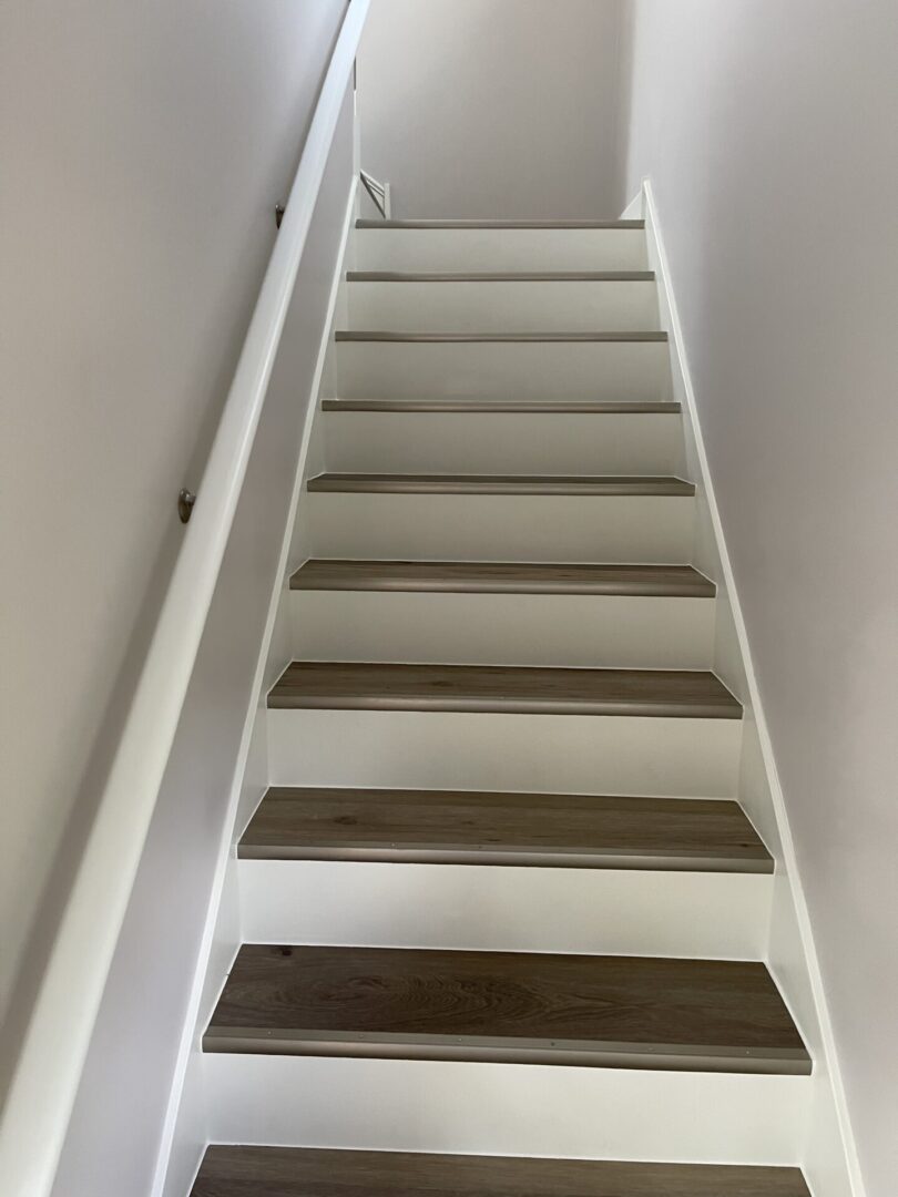 White stair treads with wood treads in a home.