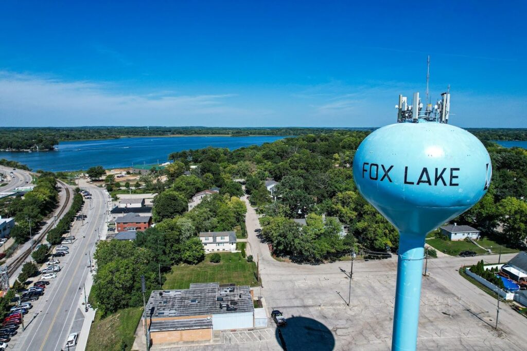 Aerial view of Fox Lake Illinois water tower near the lake and surrounding neighborhood