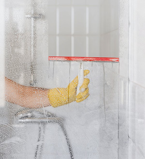 front view hand cleaning bathroom glass