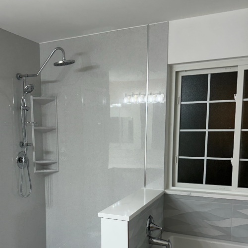 Bathroom with separate walk-in shower and freestanding bathtub facing each other, featuring small tile design and tiled walls